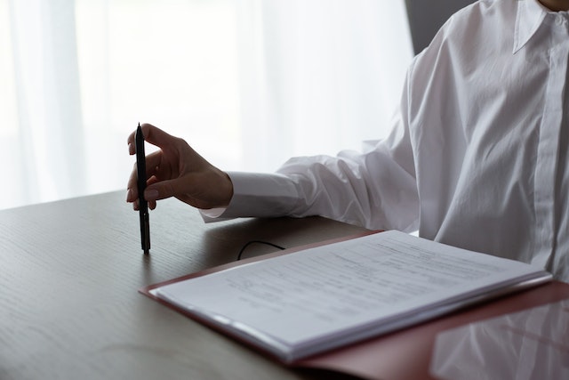 person%20holding%20pen%20before%20signing%20lease%20contract person%20holding%20pen%20before%20signing%20lease%20contract